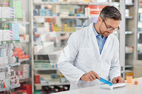 Image of Pharmacist man, store and counting with pills, medicine and focus for health, product or sales. Medical professional, pharma expert or sorting medication in pharmacy for wellness, healthcare and job