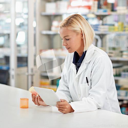 Image of Woman pharmacist in pharmacy, tablet and pill bottle for medical research and check side effects of medicine. Technology, internet with online info on pharmaceutical drugs and health professional