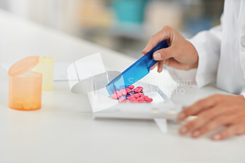 Image of Hands, pharmacist and counting pills for drug dose, packaging or prescription at a pharmacy. Hand of doctor working with medication tablets or pharmaceutical drugs for healthcare on counter at clinic