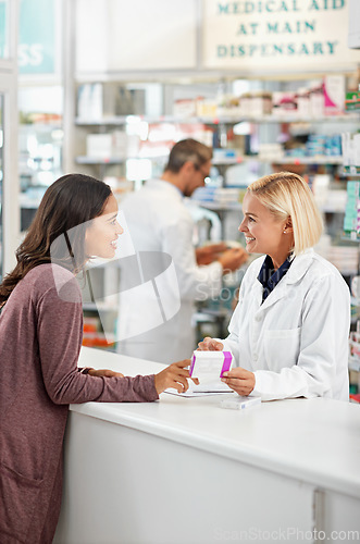 Image of Wellness, health and happy pharmacy customer at store counter for medicine expertise with smile. Pharmaceutical advice and opinion of woman pharmacist helping girl with medication information.