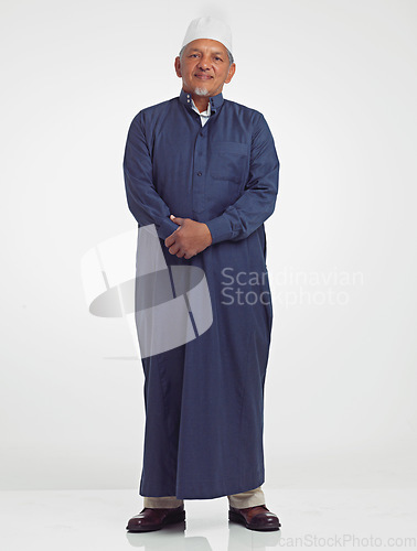 Image of Muslim old man, studio portrait and islamic culture standing isolated on white background with arabic clothes. Senior moslem person, eid mubarak and spiritual worship for ramadan, fasting or allah.