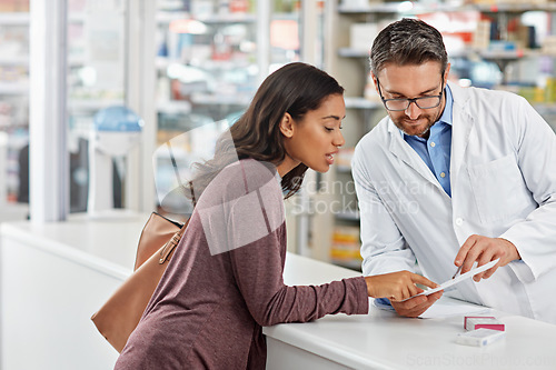 Image of Customer, service and medicine prescription at pharmacy with help from healthcare expert at store counter. Professional advice and opinion of pharmacist helping girl with medication information.