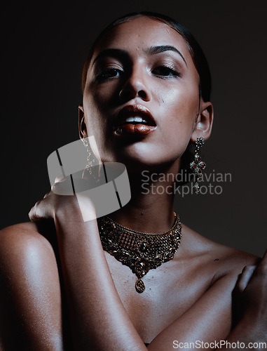 Image of Beauty, jewellery and portrait of a woman in a studio with elegant, fancy and stylish accessories. Cosmetic, style and female model from Mexico with beautiful jewelry posing by a black background.