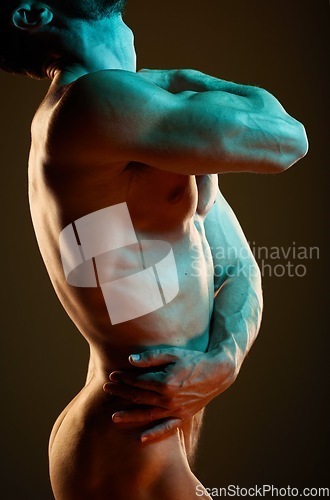 Image of Muscle, strong and body of a nude man with erotic creativity isolated on black background in studio. Creative, flexing and sexy naked model in fluorescent lighting for sensuality on a backdrop