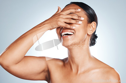 Image of Happy, laughing and woman in studio for skincare, grooming and hygiene against grey background. Beauty, joy and Mexican girl model relax with wellness, routine and skin treatment, posing and isolated