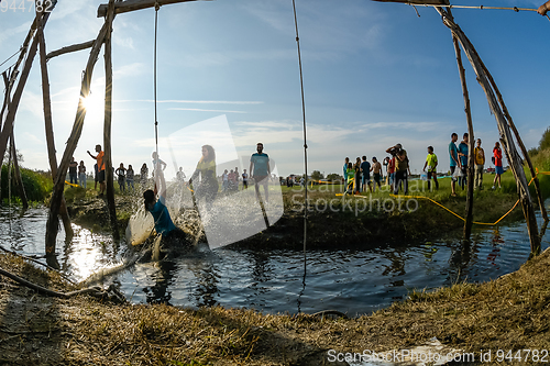 Image of Athletes go through mud and water