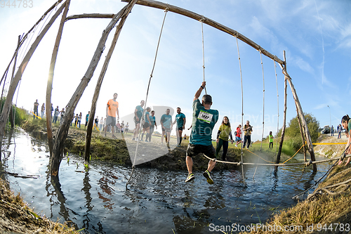 Image of Athletes go through mud and water