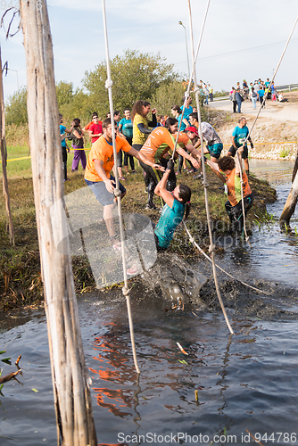 Image of Athletes go through mud and water