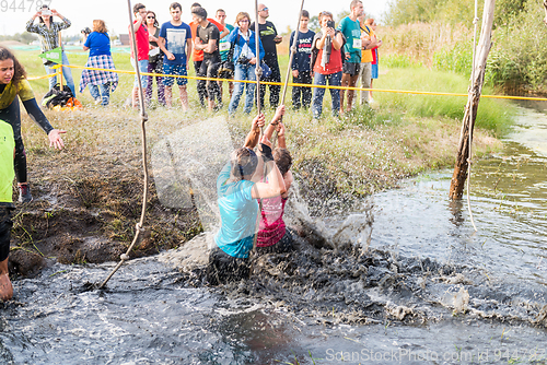 Image of Athletes go through mud and water
