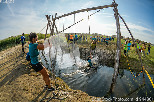 Image of Athletes go through mud and water