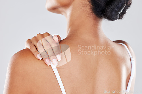 Image of Shoulder pain, injury and woman hand on her back due to hurt, inflammation or muscle strain isolated in a studio gray background. Stress, spa and massage by model for body health or wellness