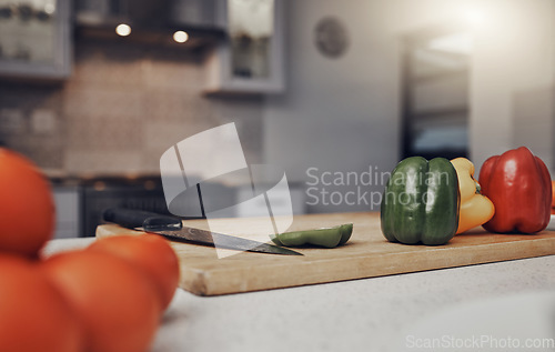 Image of Kitchen, table and cutting board with vegetables of colorful peppers for healthy meal preparation at home. Food, cooking or nutrition of organic grown consumables on counter for diet plan or vitamins