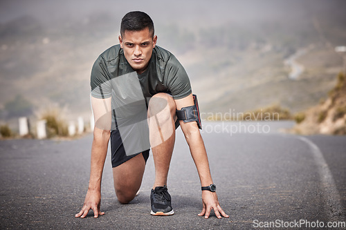 Image of Runner, start and man race in road for cardio exercise, workout and urban fitness on mountains. Sports person, athlete and guy ready to begin running in street, sprint and focus on marathon training