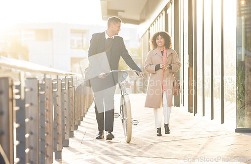 Image of Business couple, bicycle and walking outdoor in urban city for freedom, relax conversation and travel commute. Businessman, woman smile and happy speaking together on bike walk for carbon footprint