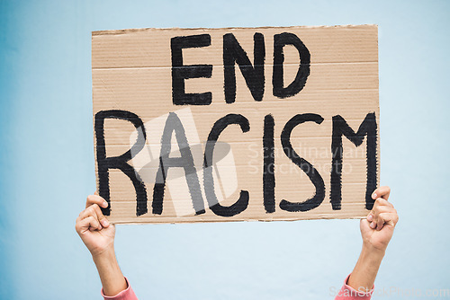 Image of Hands, cardboard poster and end racism for protest, march or community advertisement against studio background. Hand of activist holding billboard, banner or sign for equality, message or protesting