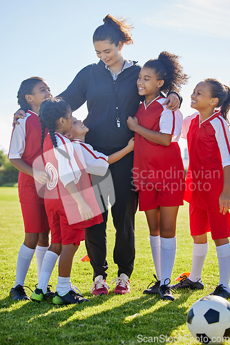 Image of Soccer, girl group hug and coach with happiness, smile or team building, diversity and solidarity on grass pitch. Young female kids, football coaching or love for mentor woman on field for motivation