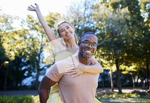 Image of Interracial couple, piggy back and portrait of people with love, care and smile on summer park date. Happiness, hug and young man and woman outdoor on adventure together happy with bonding in nature