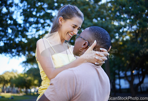 Image of Love, park and laugh with an interracial couple bonding outdoor together on a romantic date in nature. Summer, romance and diversity with a man and woman dating outside in a green garden