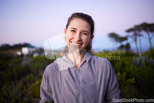 Image of Happy, sunset and portrait of a woman in a park during dusk for peace, calm and zen. Adventure, hike and face of a girl on a walk for fitness, summer cardio and relaxing during dawn in nature