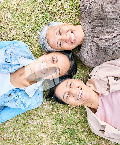 Image of Portrait, family and mother, grandmother and adult daughter relax on grass, happy and bonding in a garden. Face, generations and women having fun, laughing and enjoying the weekend at a park together