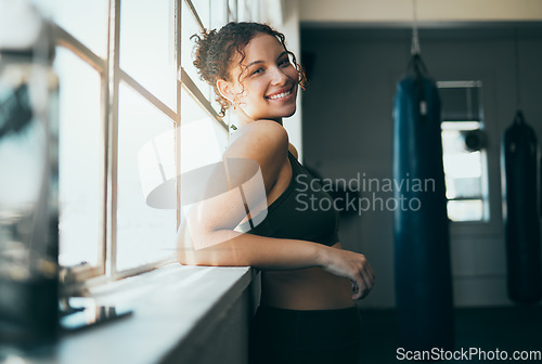 Image of Portrait, window and woman with smile, fitness and workout for wellness, healthy lifestyle or exercise. Happy female, lady or athlete in gym training, sunshine or practice for cardio, energy or power
