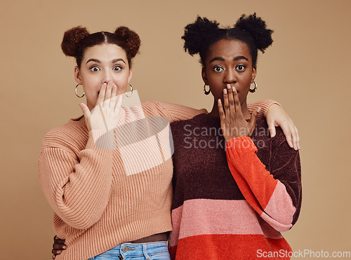 Image of Surprise, portrait and girl friends with wow face of young women with secret and brown studio background. Gen z student surprised chat together with whisper and excited discussion with shock story