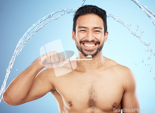 Image of Water splash, portrait or man brushing teeth in studio with toothbrush for white teeth or dental healthcare. Face, bamboo wood or happy person cleaning or washing mouth with a healthy natural smile