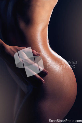 Image of Body, beauty and nude with a model woman posing sexy or seductive in studio on a dark background. Art, naked and sensual with an attractive young female standing to promote erotic or sexual freedom