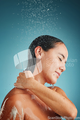 Image of Water splash, cleaning and shower of a young model woman holding her back to clean with soap. Bathroom hygiene, wellness and beauty of a person morning routine for healthy skin and skincare