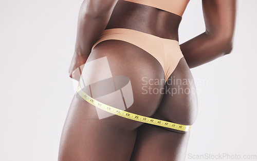 Image of Diet, body and ass of woman with tape measure to track progress, check fitness results and measure hip. Lose weight motivation, wellness lifestyle and underwear butt of slim black girl with self care