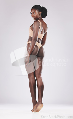 Image of Woman, beauty and skincare in underwear on a white studio background for body wellness. African american female, beauty and skin care or bodycare for fitness and smooth or glowing radiant skin