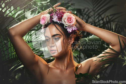 Image of Beauty, forest and face of a woman with a flower crown standing by a tropical leaf background. Cosmetics, skincare and model from Mexico with a wellness skin routine with green plants in nature.