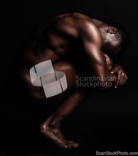 Image of Nude, art and naked body of a strong black man in dark studio for sexy muscle and sexuality. Sport person or bodybuilder model for motivation, health and wellness in art deco form or shape background