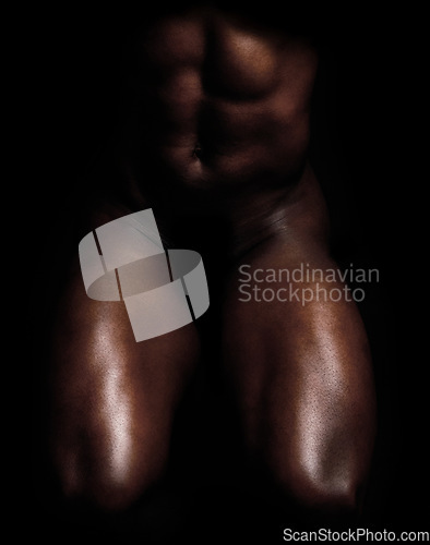 Image of Fit, strong and muscular man isolated against black background and posing nude, bare or topless. Closeup of powerful, active or athletic bodybuilder showing muscles, sensual body and male physique