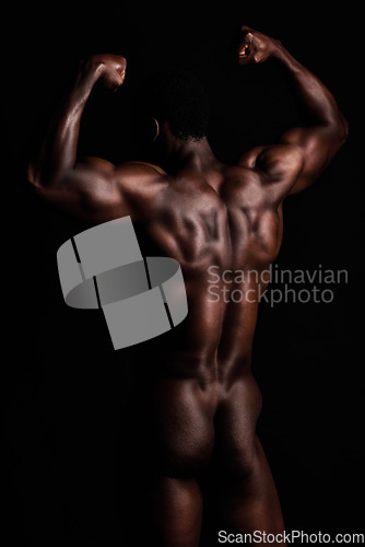 Image of Strong, body and muscle on a naked black african american man posing in studio isolated against a black background. The human body in masculine and muscular form. A show of strength and dedication