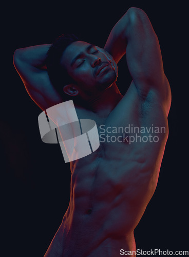 Image of Naked, art and freedom with a model asian man in studio on a dark background for artistic body positivity. Skin, natural and artwork with a handsome young male posing nude on a black backdrop