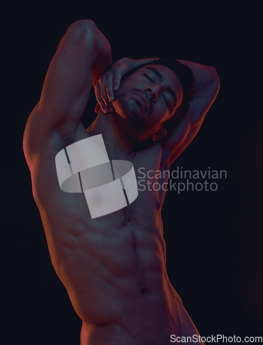 Image of Nude, skin and freedom with a model asian man in studio on a dark background for artistic body positivity. Art, natural and artwork with a handsome young male posing naked on a black backdrop