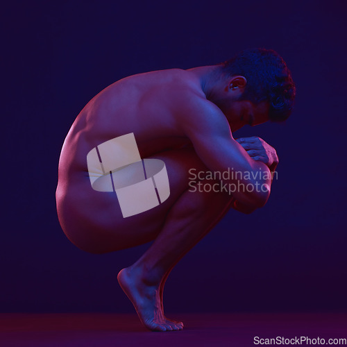 Image of Nude, art and fetal with a model asian man in studio on a dark background for artistic body positivity. Skin, natural and freedom with a handsome young male posing naked on a black backdrop