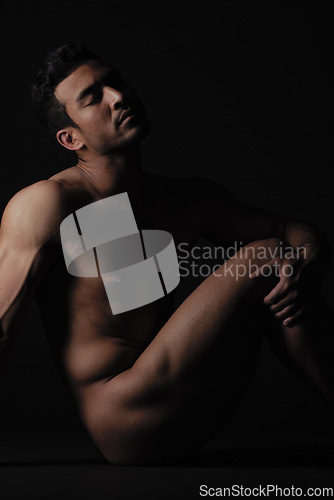 Image of Nude, art and freedom with a model asian man in studio on a dark background for artistic body positivity. Skin, natural and artwork with a handsome young male posing naked on a black backdrop