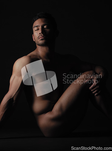 Image of Nude, art and sensual with a model asian man in studio on a dark background for artistic body positivity. Skin, natural and artwork with a handsome young male posing naked on a black backdrop