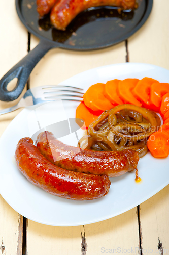 Image of beef sausages cooked on iron skillet