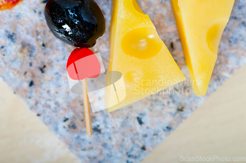 Image of mix cold cut on a stone with fresh pears