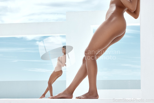 Image of Women, nude or body pose by wall, creative building or blue sky background in self love, acceptance or empowerment. Beauty model, naked or people legs in wellness art, sexy Brazil skincare or freedom