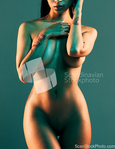 Image of Neon, sexy and body of naked woman on blue background for sensuality, seductive and sexual freedom. Art deco, studio lighting and torso of attractive female with beautiful, erotic and glowing skin