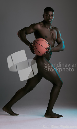 Image of Black man, basketball and fitness model portrait of a person with a sport ball naked. Grey studio background, isolated and nude male body ready for athlete training for wellness in a studio alone