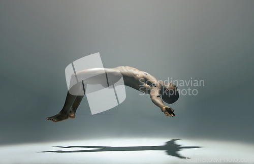 Image of Float, man and naked model in a white background studio for creative art with shadow. Isolated, floating and nude body of a african male in the air with light showing artistic and erotic projection