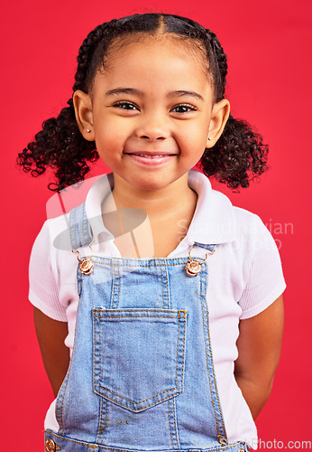 Image of Portrait, child and girl in studio, happy and smile against a red background with mockup. Face, cheerful and trendy toddler standing against space, excited and positive, smiling and posing isolated