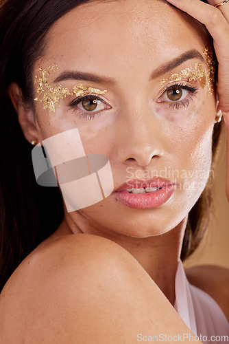 Image of Cosmetics, portrait and woman with glitter, skincare and confident girl on brown studio background. Face, female and lady with makeup, glamour and dermatology for natural beauty, smooth or clear skin