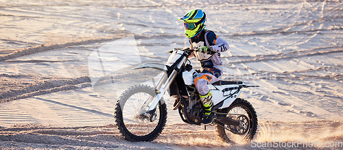 Image of Motorcycle, desert race and extreme sport expert with agile speed, power or balance in nature. Motorbike man, rally and sand on fast vehicle with helmet, safety clothes and motivation for motorsport