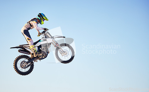 Image of Motorcycle, jump and person on blue sky mockup for training, competition or challenge with safety gear. Professional cycling, motorbike and adventure with speed, sports and danger in mock up space